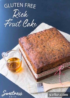 Gluten-Free Cake Recipes for Decorating 10 A square gluten free rich fruit cake on a piece of parchment paper, with a small glass jug of brandy and a pastry brush