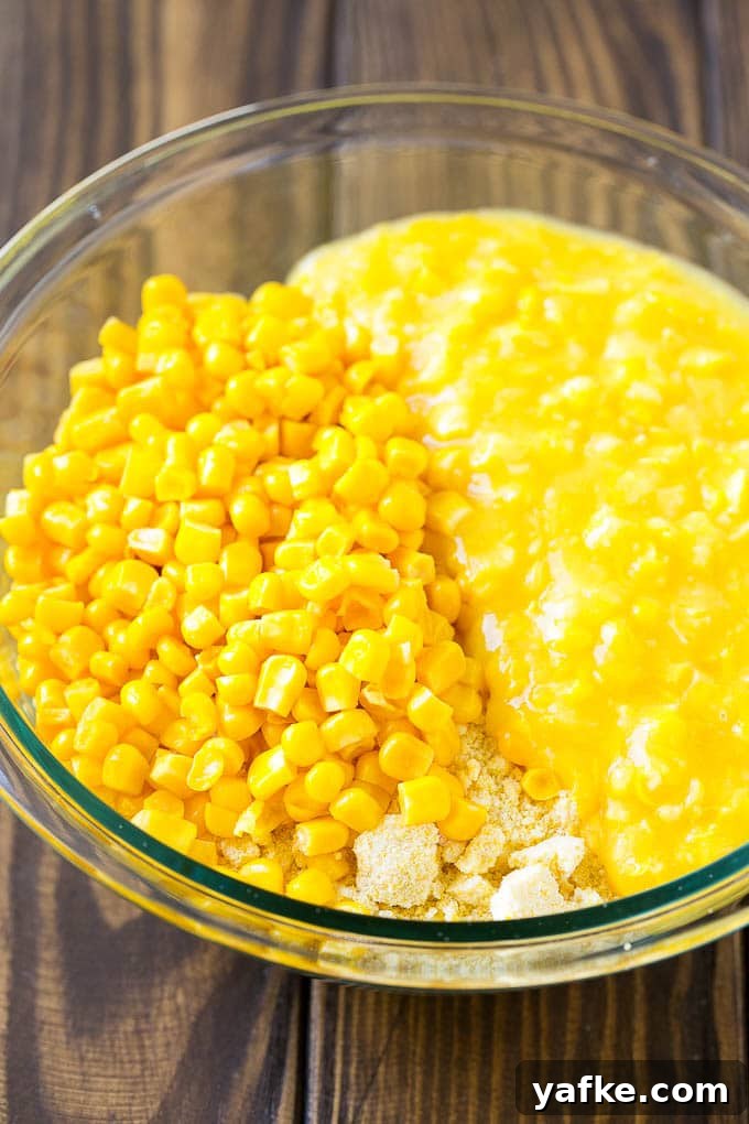Corn Pudding Recipe | Corn Casserole | Corn Side Dish Corn kernels, creamed corn and cornbread mix in a bowl.