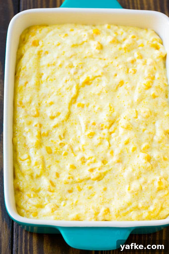 Corn Pudding Ready to Bake Batter spread into a baking dish.