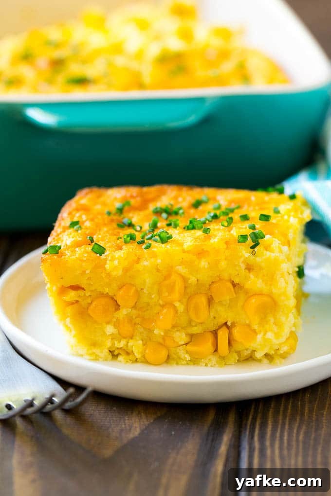 Serving of Corn Pudding A serving of corn pudding on a plate, garnished with chives.