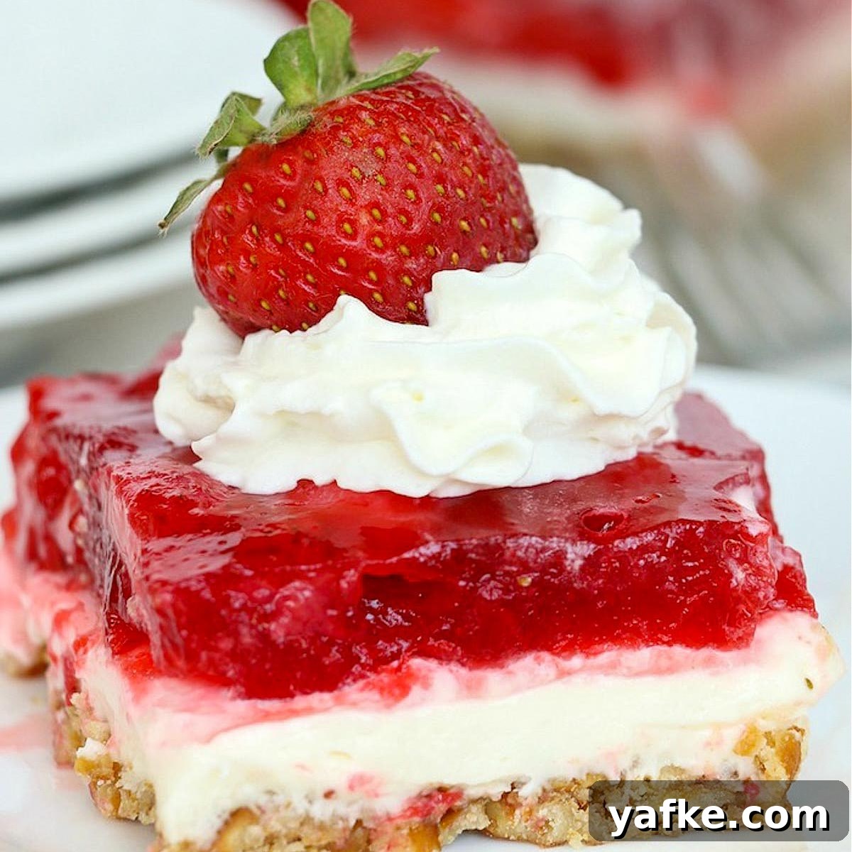 21 Patriotic Canada Day Desserts 13 a slice of strawberry pretzel dessert on a white plate