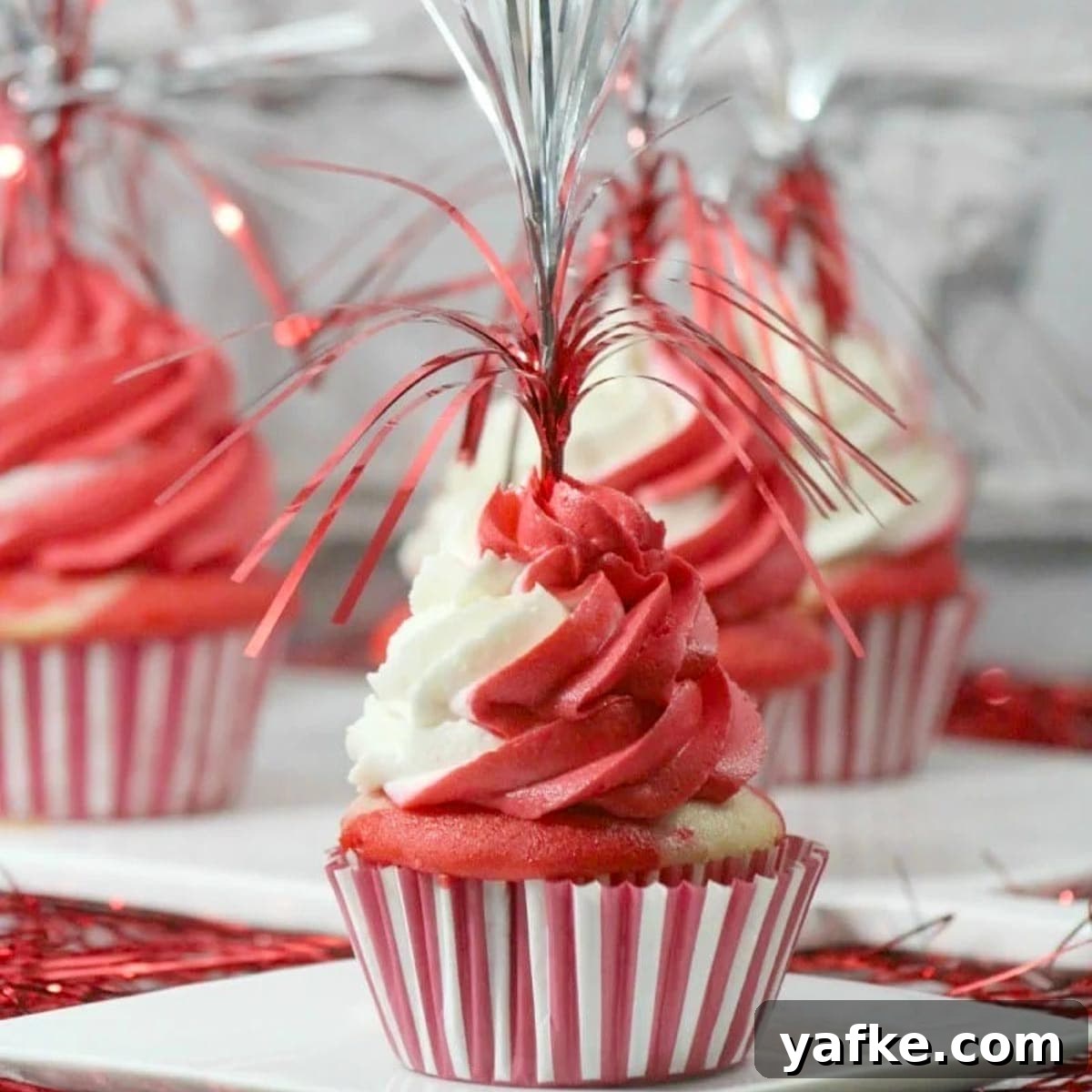 21 Patriotic Canada Day Desserts 3 Festive Canada day cupcakes on white plates