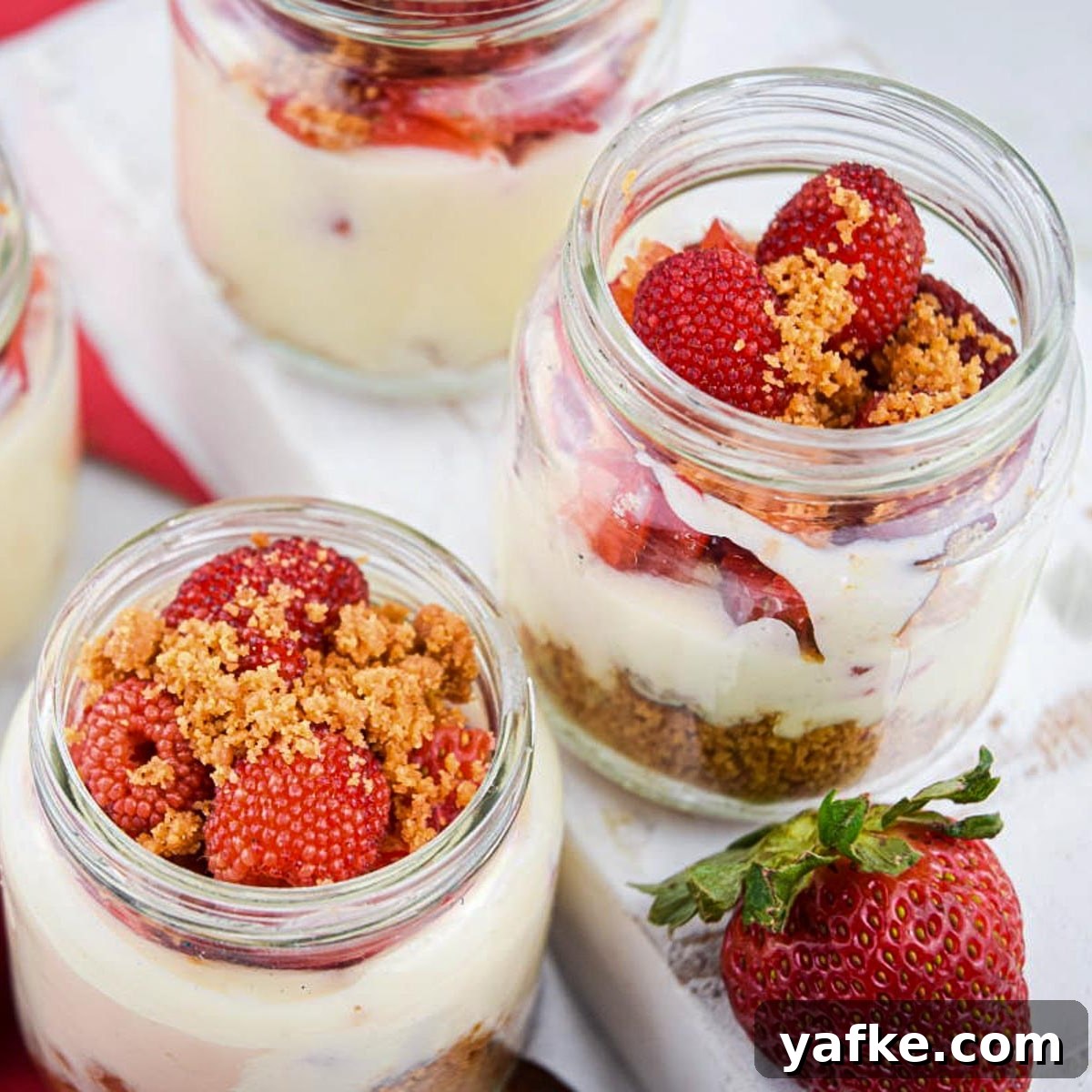 21 Patriotic Canada Day Desserts 9 raspberry cheesecake shots in jars on a white surface