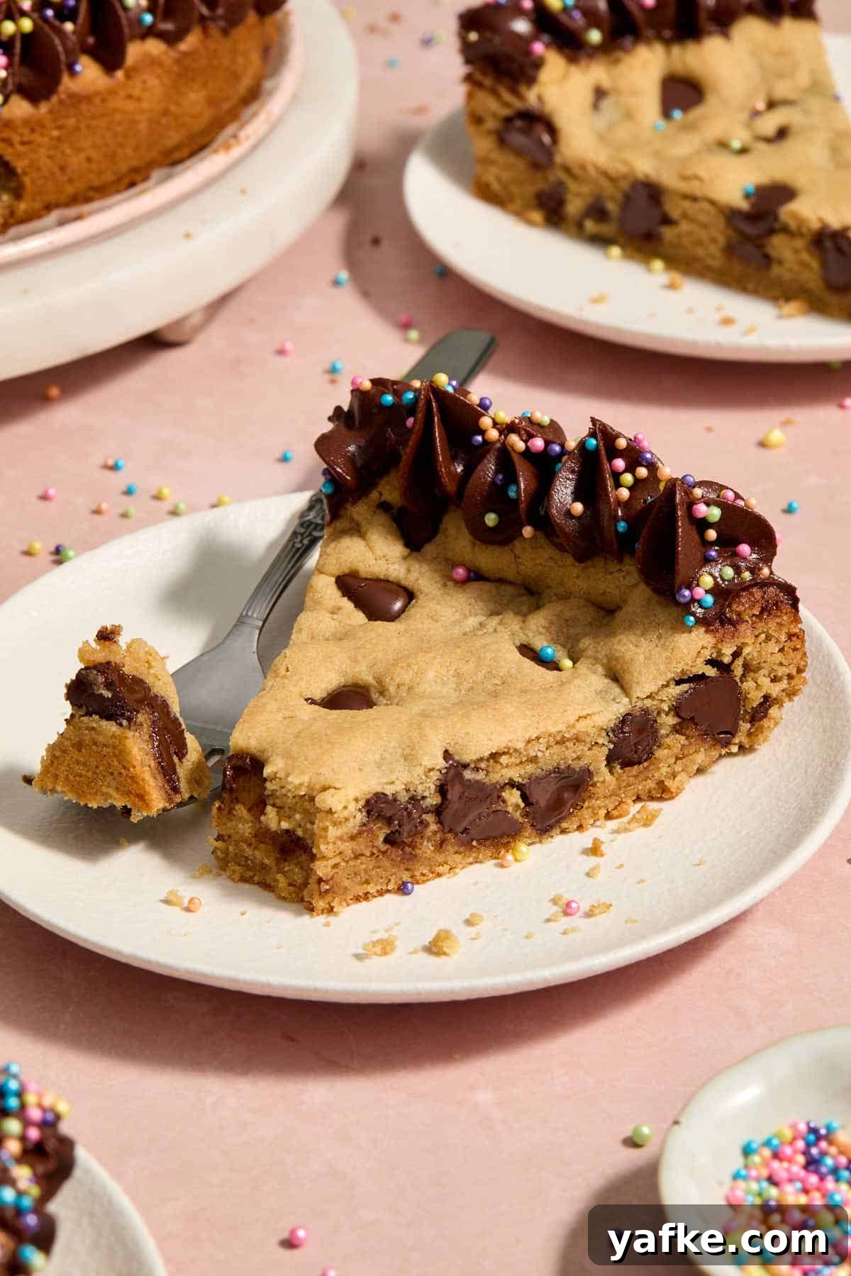 Almond Flour Cookie Cake with Peanut Butter and Chocolate Chips 2 Slice of chocolate chip cookie cake on a white plate with a forkful removed.
