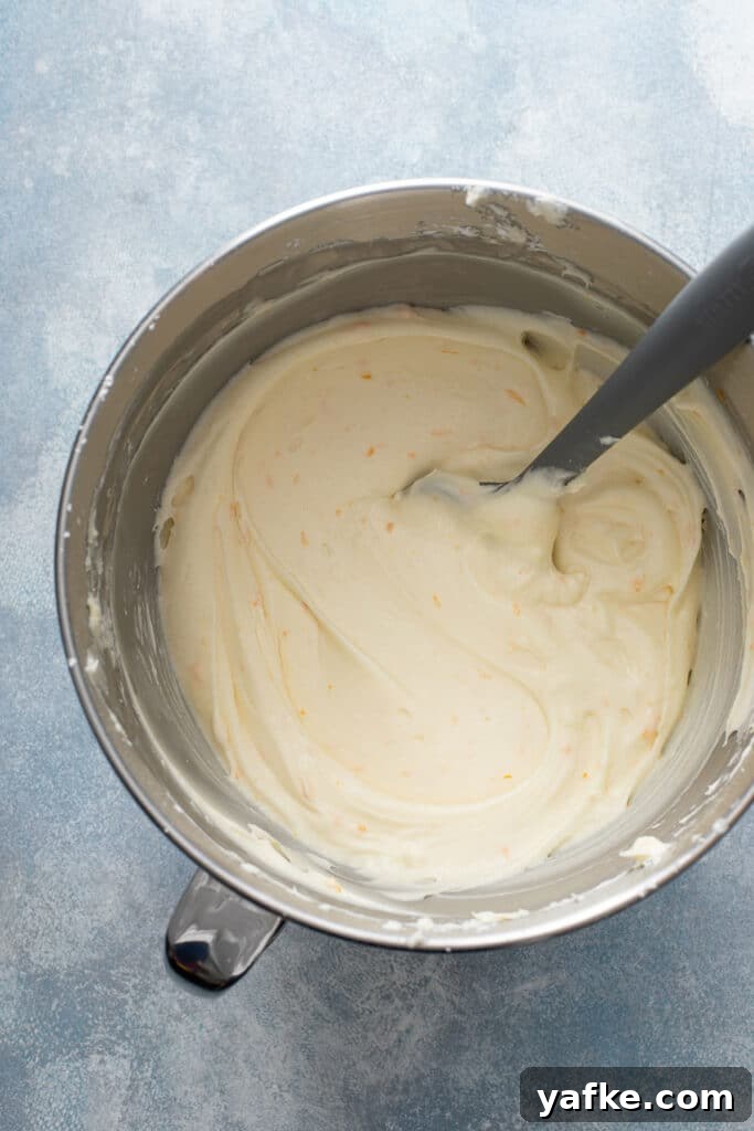 Carrot Cake Recipe with Grand Marnier Cream Cheese Frosting 12 Creamy and smooth cream cheese frosting with orange zest and grand marnier liqueur in a mixing bowl