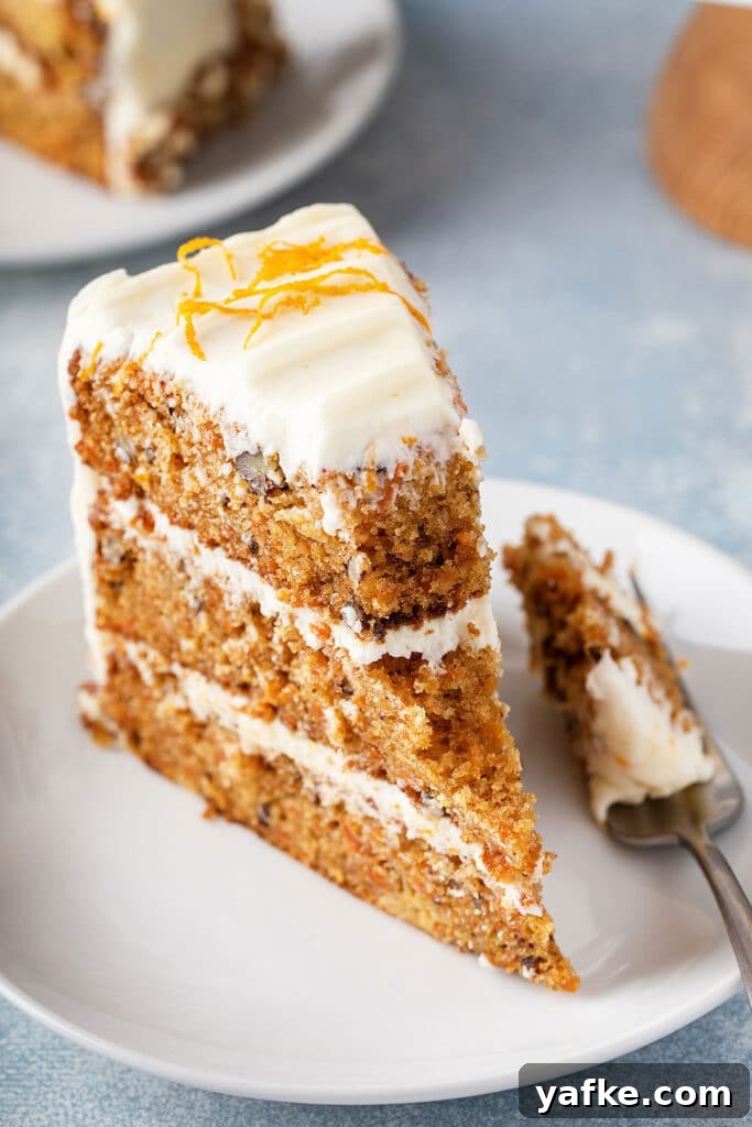 Carrot Cake Recipe with Grand Marnier Cream Cheese Frosting 14 A slice of three-layer homemade carrot cake with orange cream cheese frosting.