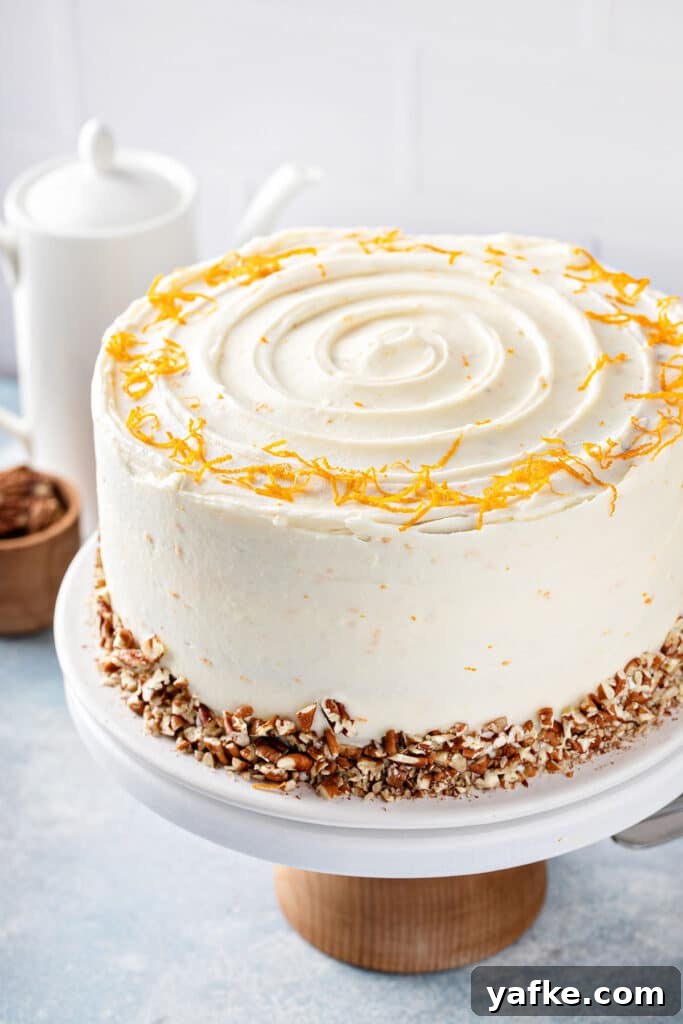 Carrot Cake Recipe with Grand Marnier Cream Cheese Frosting 3 Carrot cake frosted with smooth and silky orange grand marnier cream cheese frosting on a cake stand