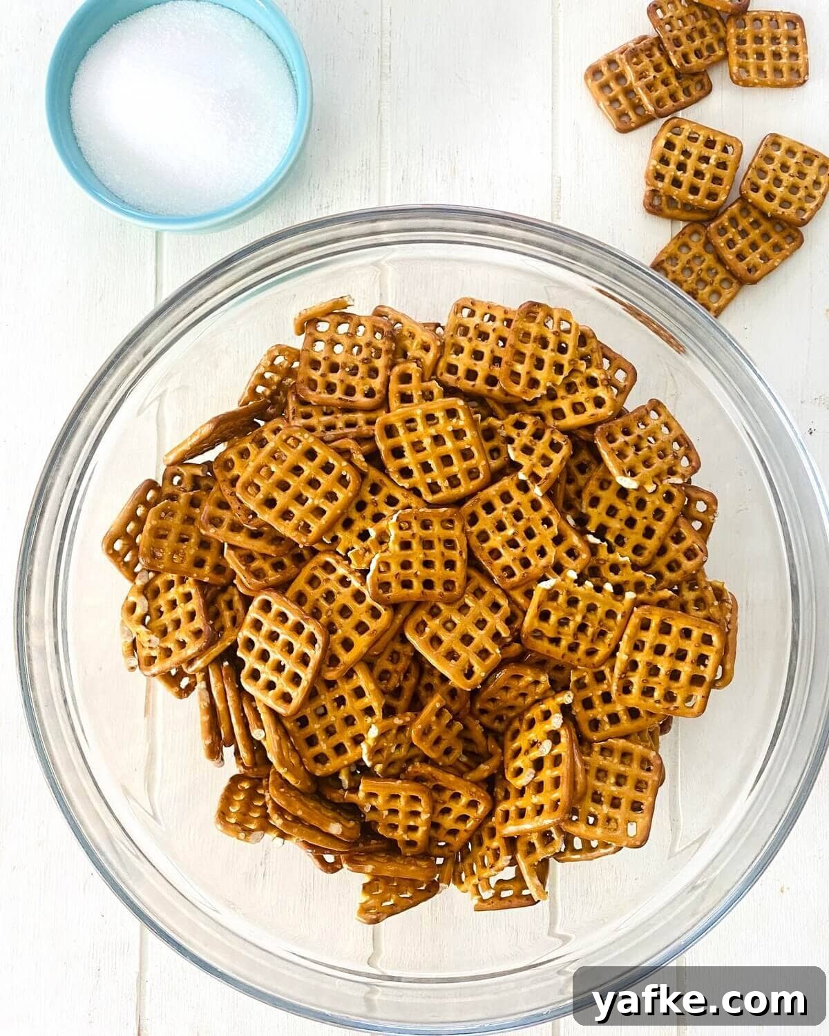 Pumpkin Spice Pretzels Drizzled with White Chocolate 4 pretzels in a bowl.