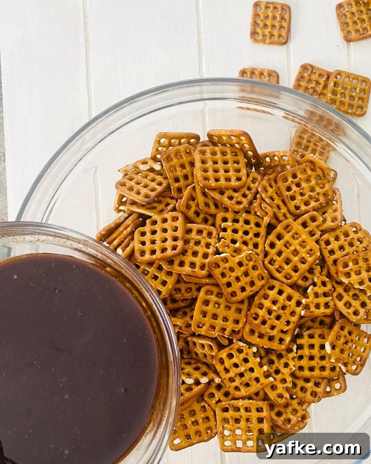 Pumpkin Spice Pretzels Drizzled with White Chocolate 6 adding pumpkin spice to pretzels.