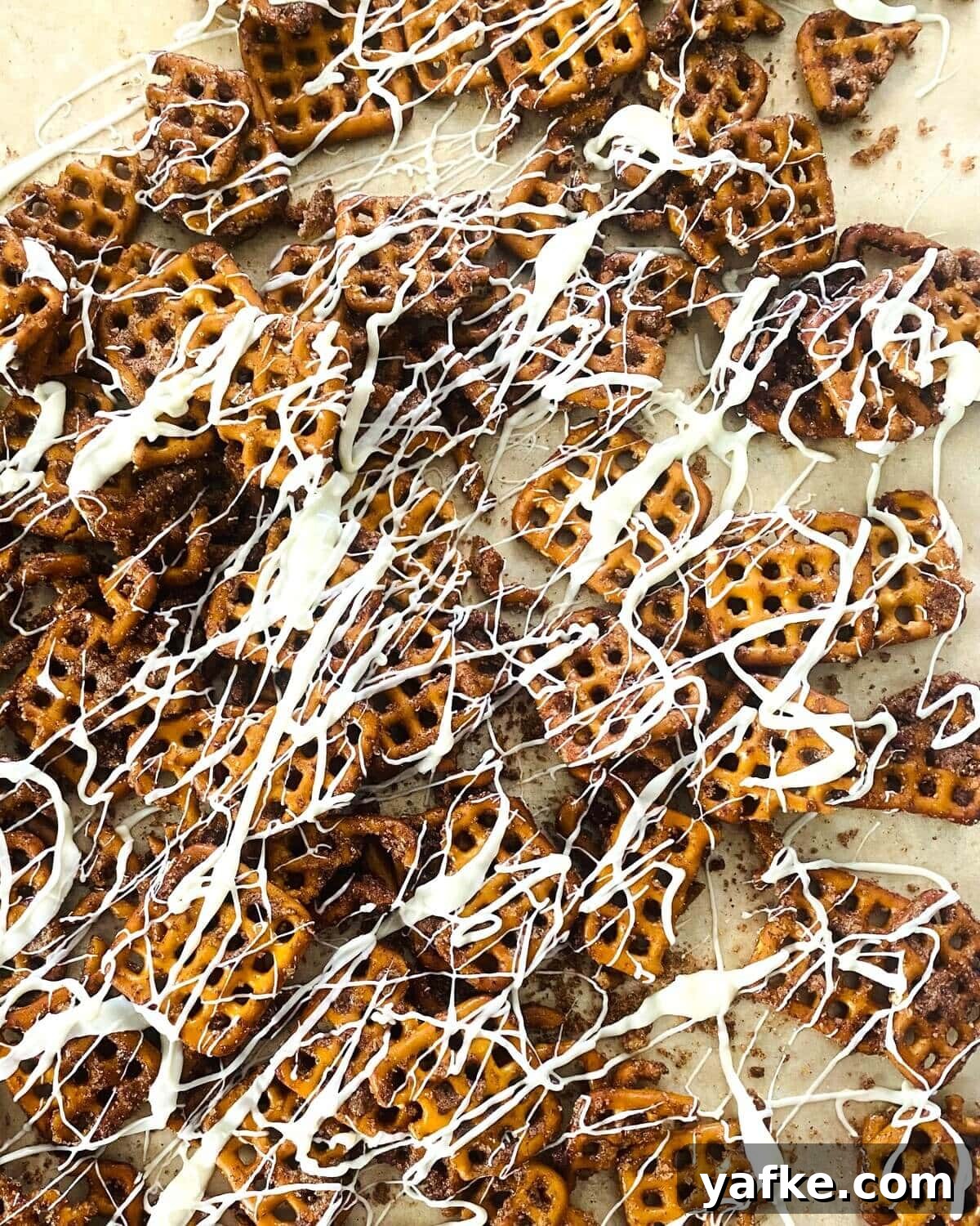 Pumpkin Spice Pretzels Drizzled with White Chocolate 9 white chocolate drizzled pumpkin spiced pretzels.