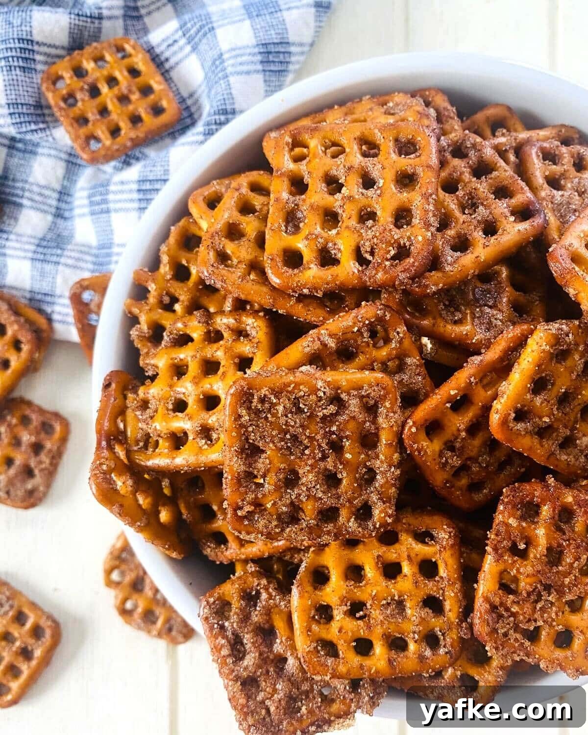 Pumpkin Spice Pretzels Drizzled with White Chocolate 10 pumpkin spiced pretzels in a bowl.