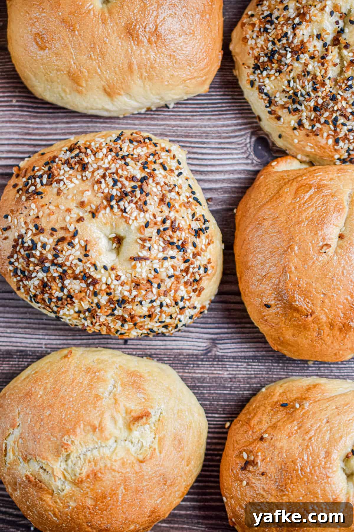 New York-Style Bagels Made with Sourdough Discard 2 Six sourdough discard bagels are laid out with two everything bagels in the mix.