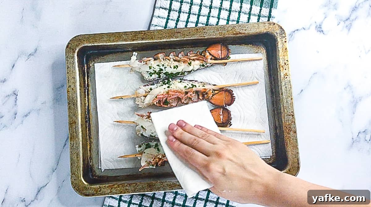 How to Make Sous Vide Lobster Tail with Buttery Sauce 7 Skewered lobster tails in a pan.
