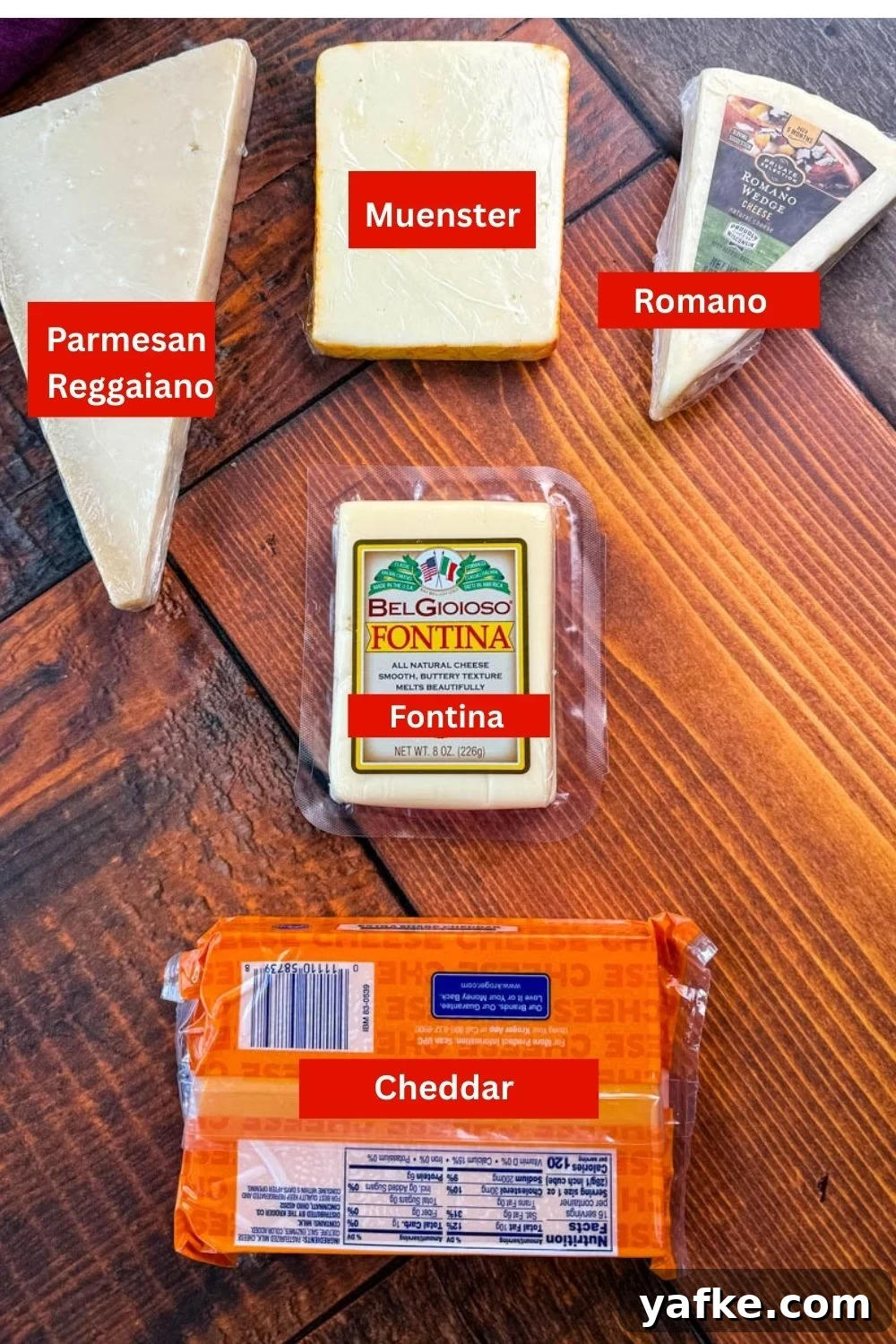 Southern Soul Food Baked Mac and Cheese Recipe 3 Five different types of cheese displayed on a wooden table: Parmesan wedge, smoked gouda block, Romano wedge, packaged Fontina, and a block of cheddar cheese.
