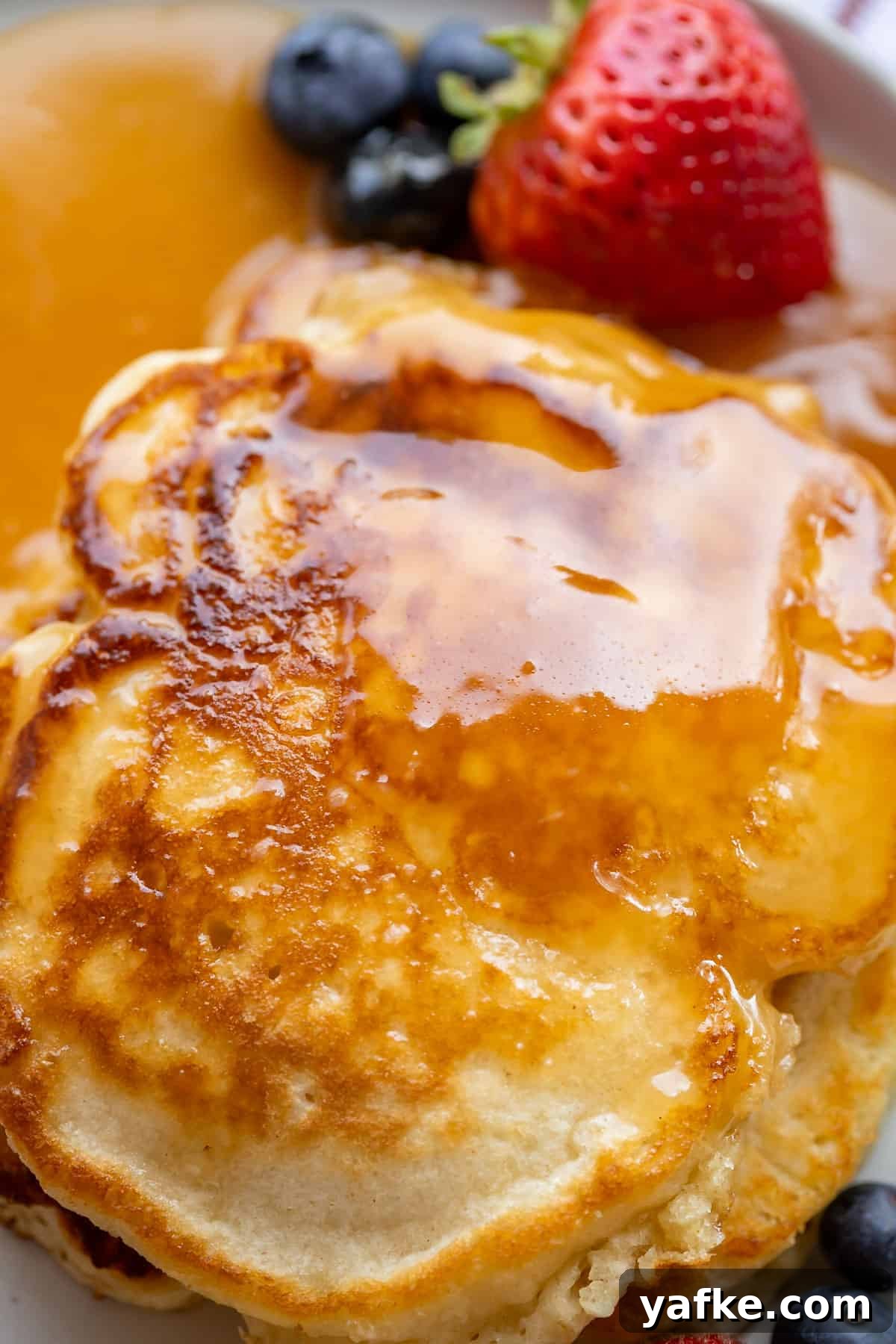 Homemade Buttermilk Syrup for Pancakes and Waffles 3 overhead shot of buttermilk syrup recipe on a plate with fruit.