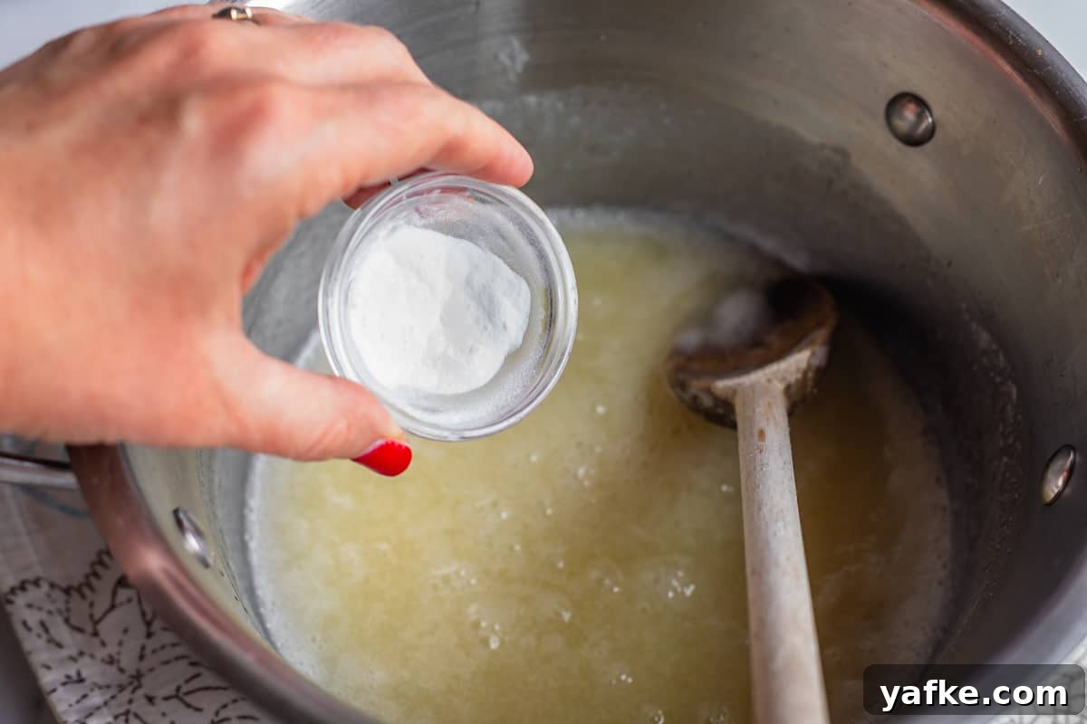 Homemade Buttermilk Syrup for Pancakes and Waffles 7 Adding baking soda to a pot of boiling liquid.