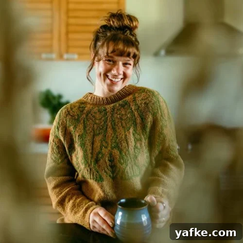 Coconut Meringue Pie with Toasted Coconut Topping 3 Smiling woman in a brown sweater holding a mug, sitting in a cozy kitchen.