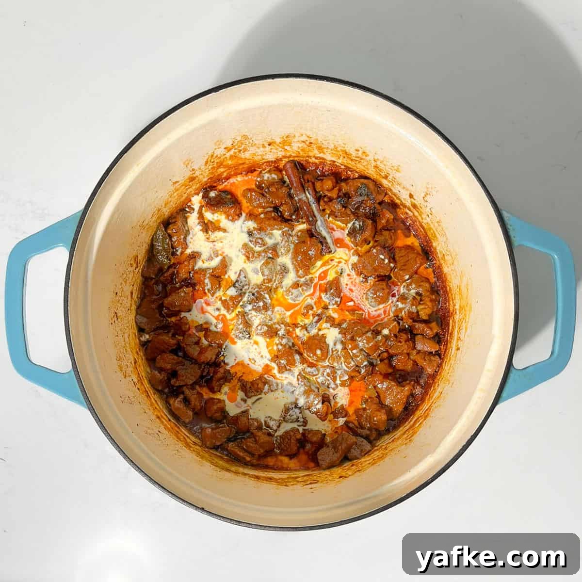 Creamy Beef Curry with Coconut Milk Recipe 12 Adding cream to the beef coconut curry.