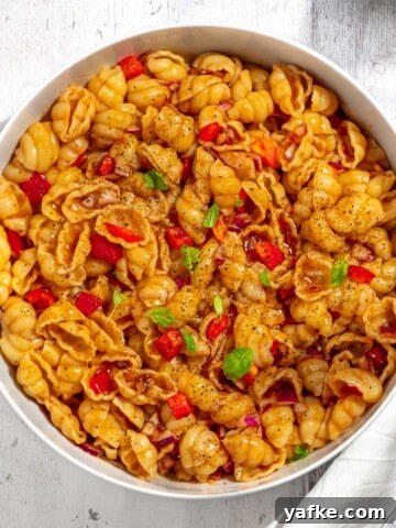 Curry noodle salad in a large white bowl.