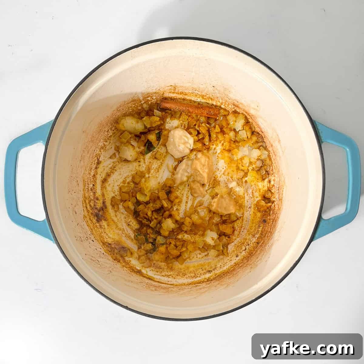 Creamy Beef Curry with Coconut Milk Recipe 8 Adding garlic and ginger to the fried onions in a large saucepan.