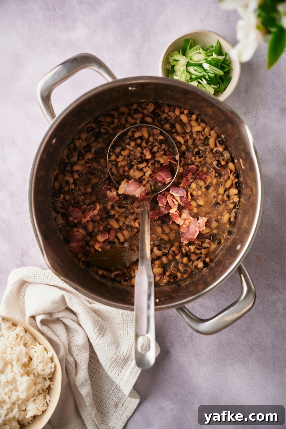 Large pot with hoppin' john and a ladle in the pot.