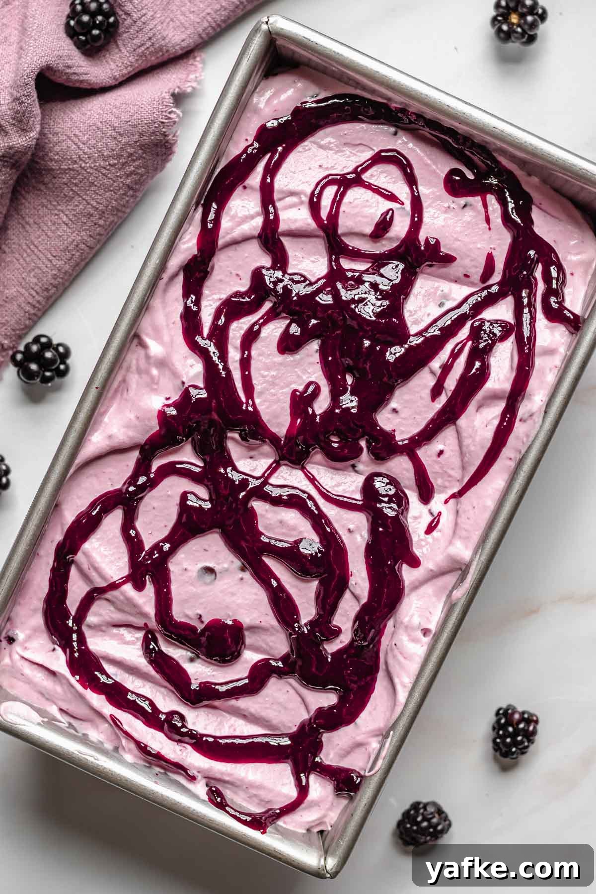 Creamy No-Churn Blackberry Chocolate Chip Ice Cream Recipe 11 Black raspberry puree drizzled on top of the ice cream.