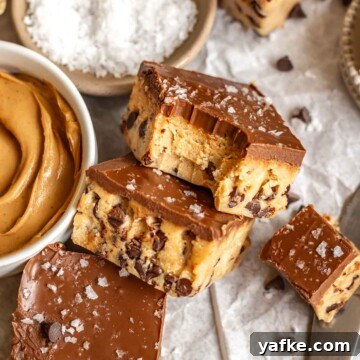Creamy No-Churn Blackberry Chocolate Chip Ice Cream Recipe 16 Peanut butter cookie dough bites leaning against each other. One has a bite removed.