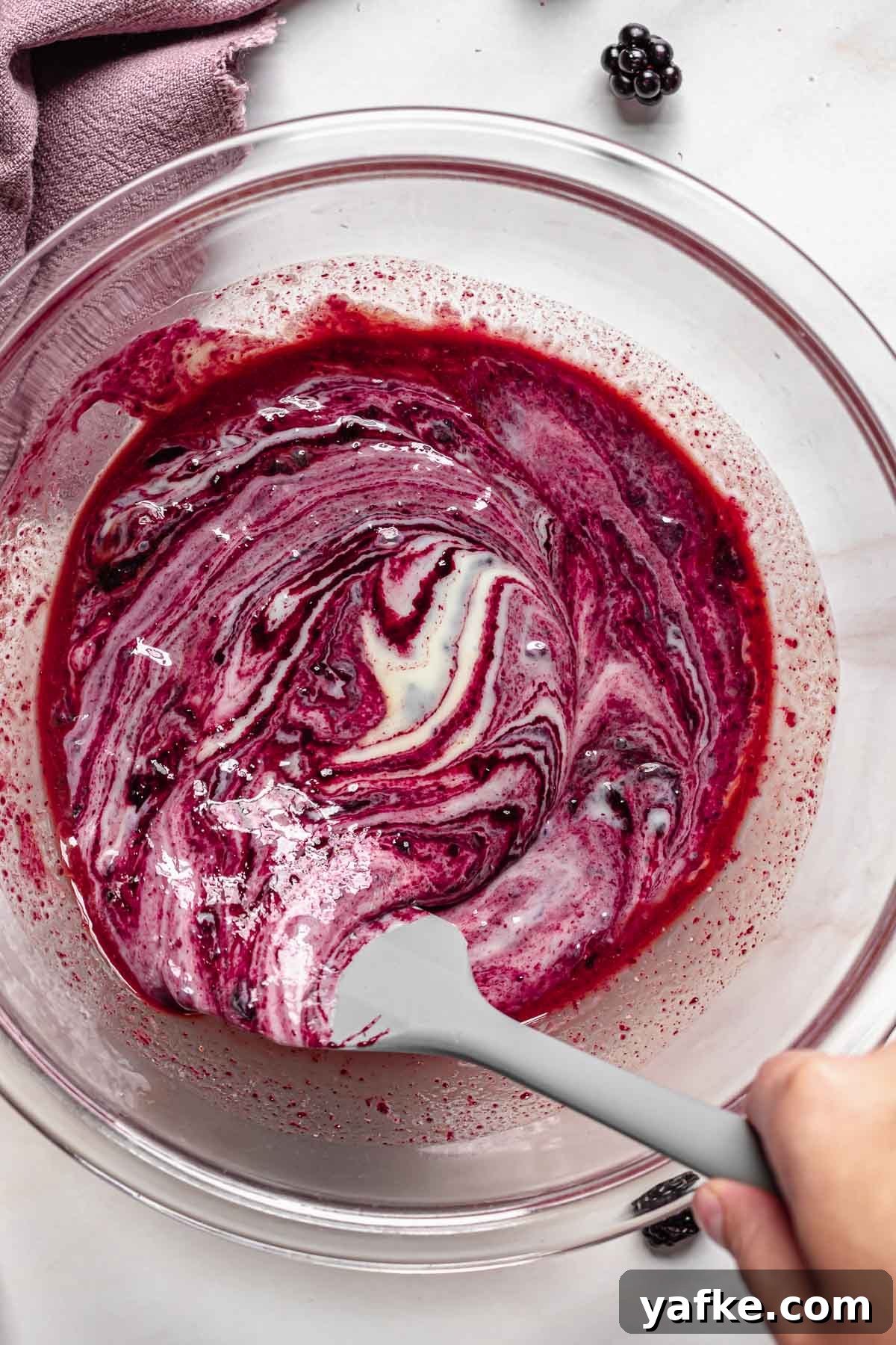 Creamy No-Churn Blackberry Chocolate Chip Ice Cream Recipe 7 Marbled black raspberry puree folding into sweetened condensed milk.