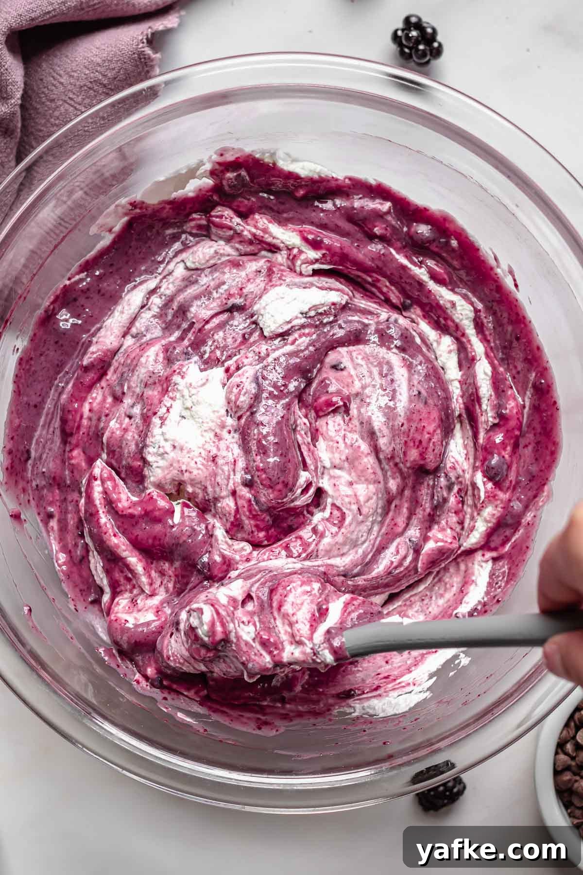 Creamy No-Churn Blackberry Chocolate Chip Ice Cream Recipe 8 Whipped cream folding into black raspberry ice cream.