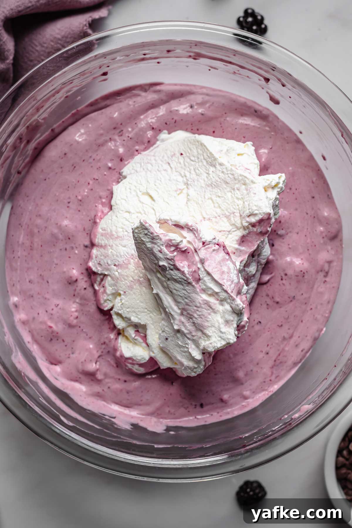 Creamy No-Churn Blackberry Chocolate Chip Ice Cream Recipe 9 Whipped cream in the bowl of soft ice cream.
