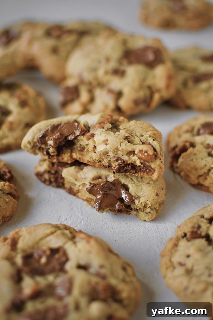 Kitchen Sink Cookies on a board, with one in the middle broken in half.