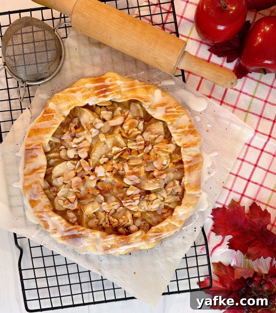 Rustic Apple Almond Galette Recipe with Flaky Crust 2 Apple Almond Galette on a cooling rack cooking with the glaze drizzled over the top.
