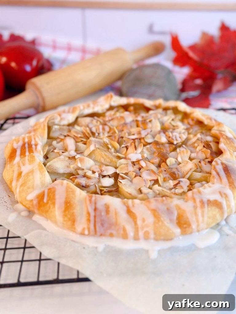Rustic Apple Almond Galette Recipe with Flaky Crust 14 Galette with icing drizzled over the top.