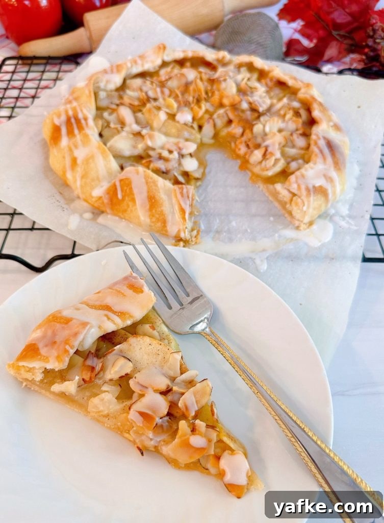 Rustic Apple Almond Galette Recipe with Flaky Crust 16 Slice of apple almond galette with a fork on a dessert plate.
