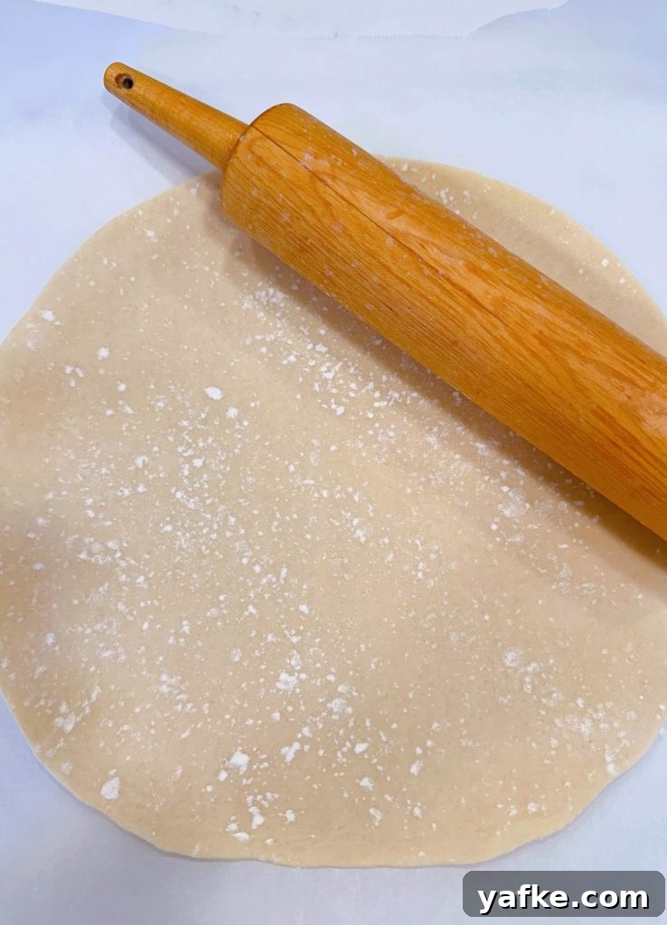 Rustic Apple Almond Galette Recipe with Flaky Crust 5 Rolling out the refrigerated pie dough into a 14-inch circle.