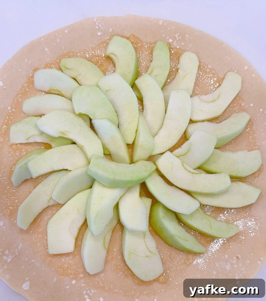 Rustic Apple Almond Galette Recipe with Flaky Crust 7 Apples arranged on the pie dough.