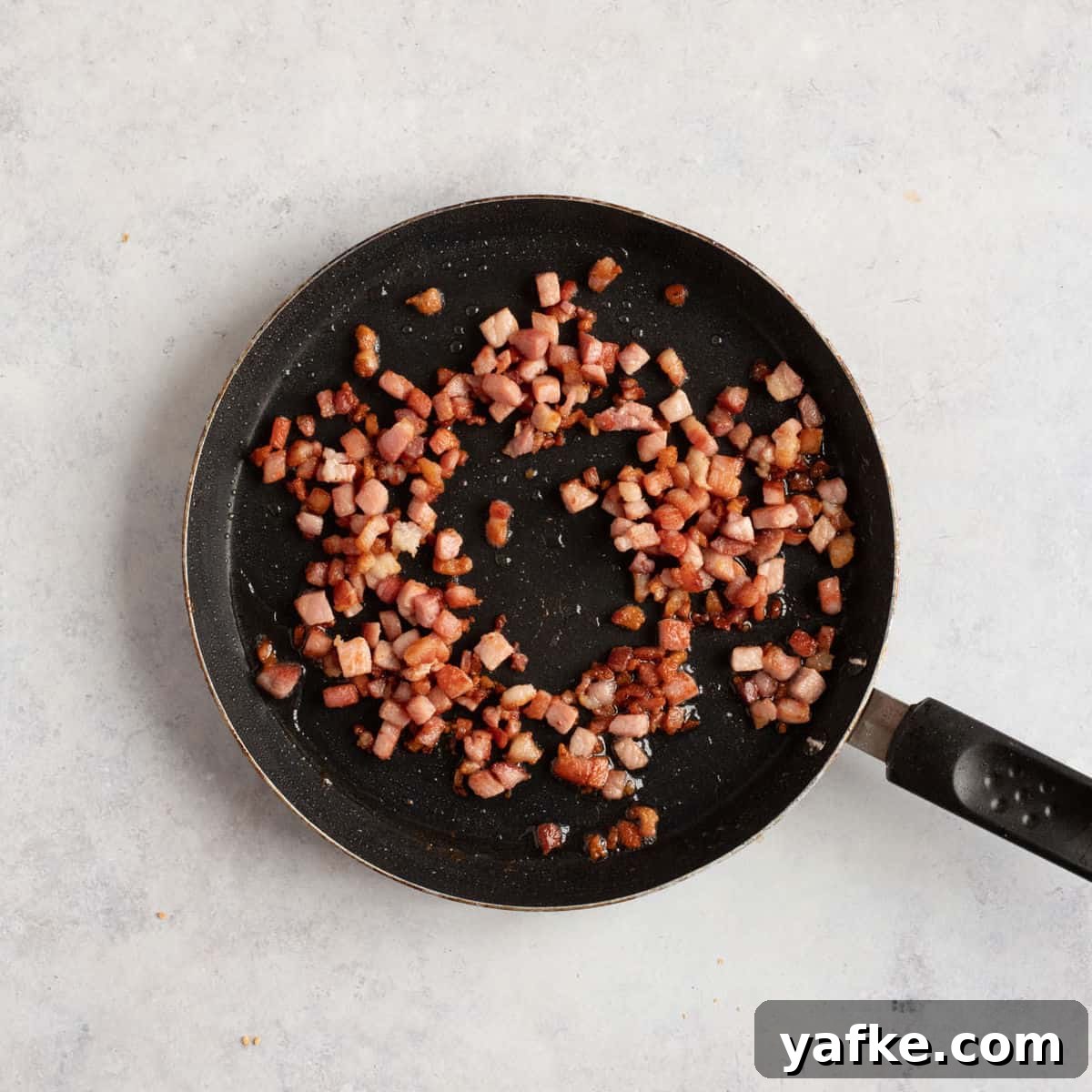 Celeriac and Bacon Soup Recipe for Soup Makers 4 Bacon lardons in a frying pan.