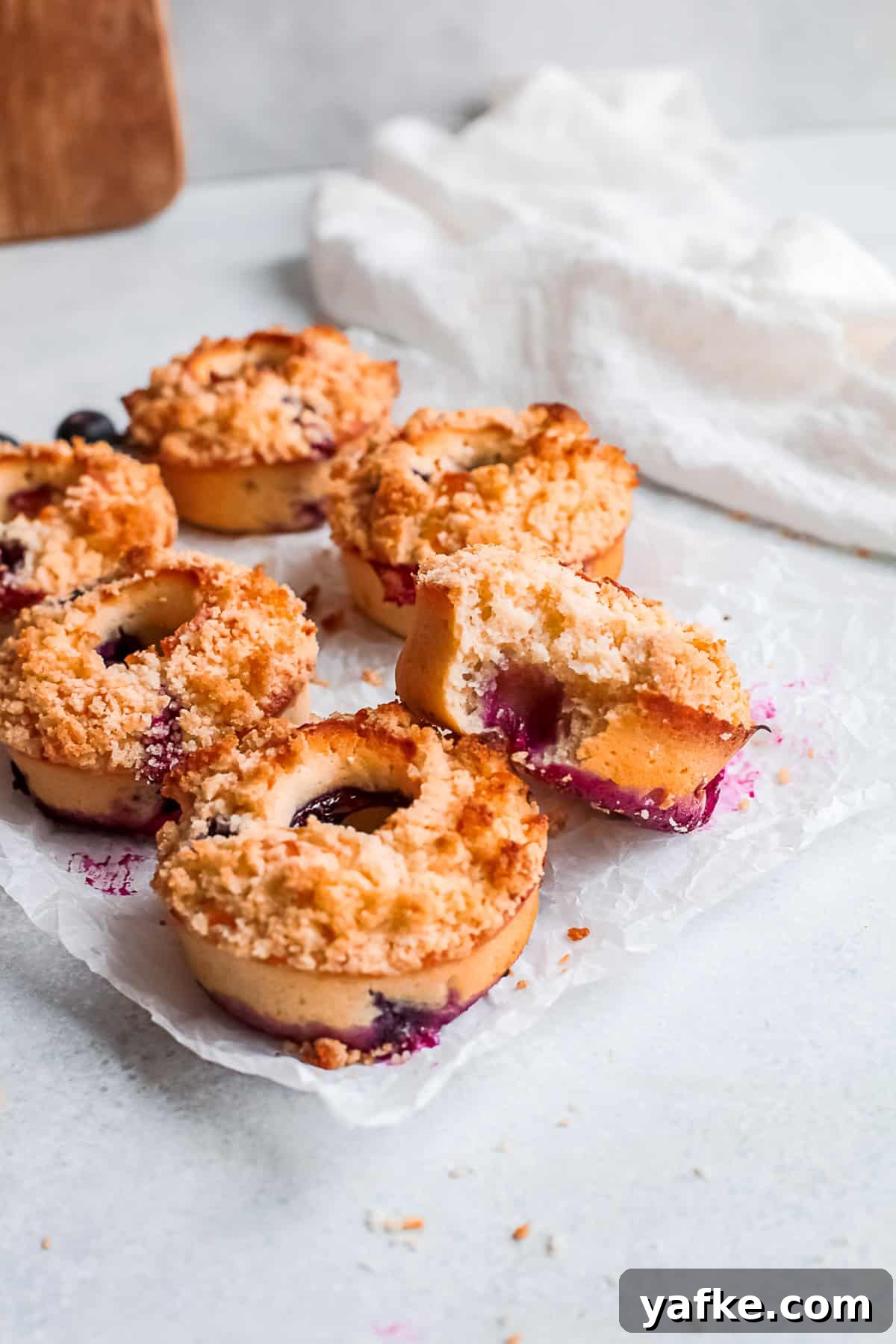 Oven-Baked Blueberry Streusel Donuts Recipe 7 Baked Blueberry Streusel Donuts topped with crunchy topping.