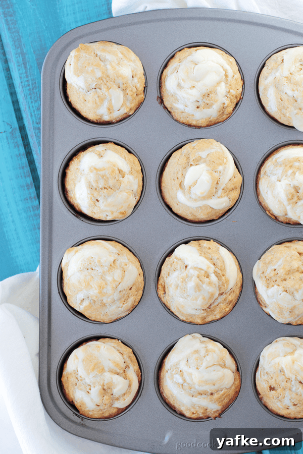 Banana Muffins with Cream Cheese Swirl Recipe 2 Banana Muffins with Cream Cheese Swirl in a muffin tin