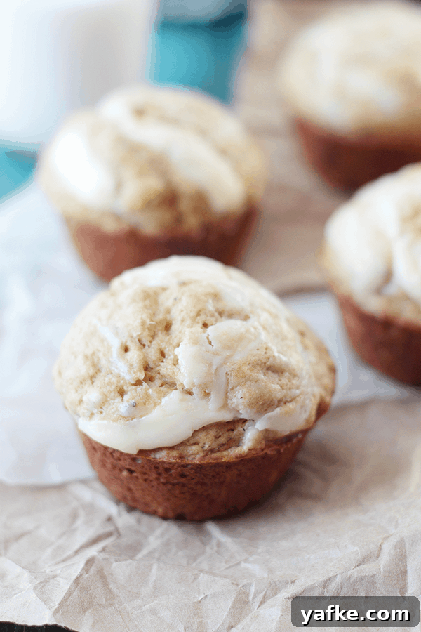 Banana Muffins with Cream Cheese Swirl Recipe 4 close up photo of a banana muffin with cream cheese swirled in