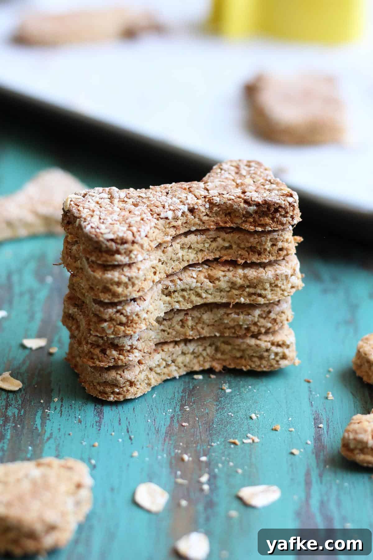 Homemade Pineapple Dog Treats Your Pup Will Love 6 A stack of bone shape pineapple treats for dogs.
