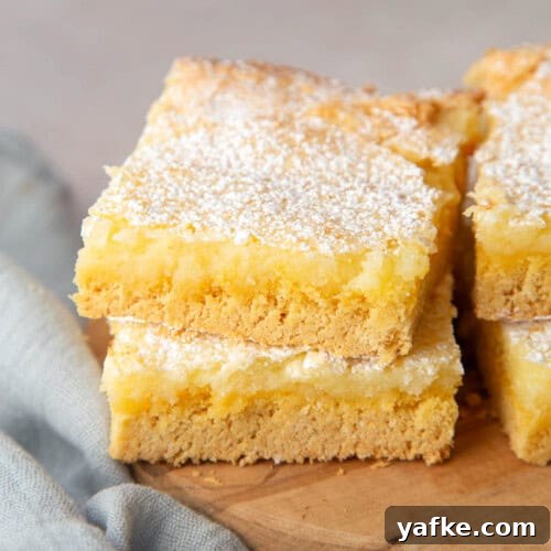 two slices of ooey gooey butter cake stacked on top of each other.