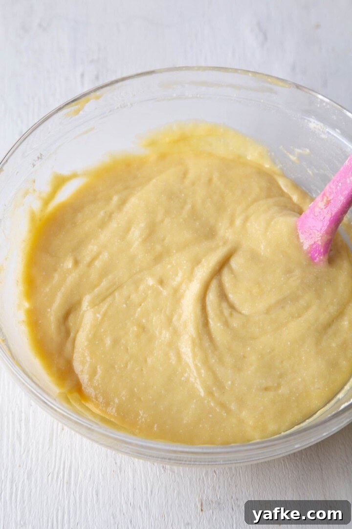 yellow cake batter in a glass bowl.