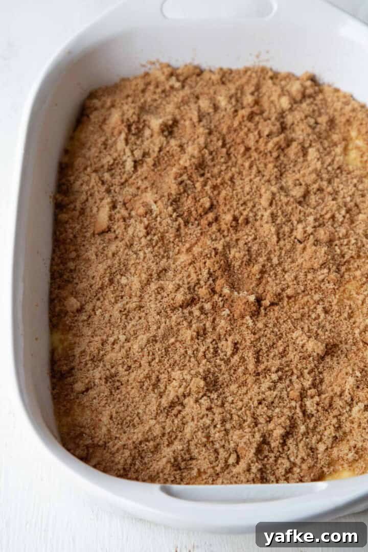 cinnamon and sugar on top of cake batter in a baking dish.