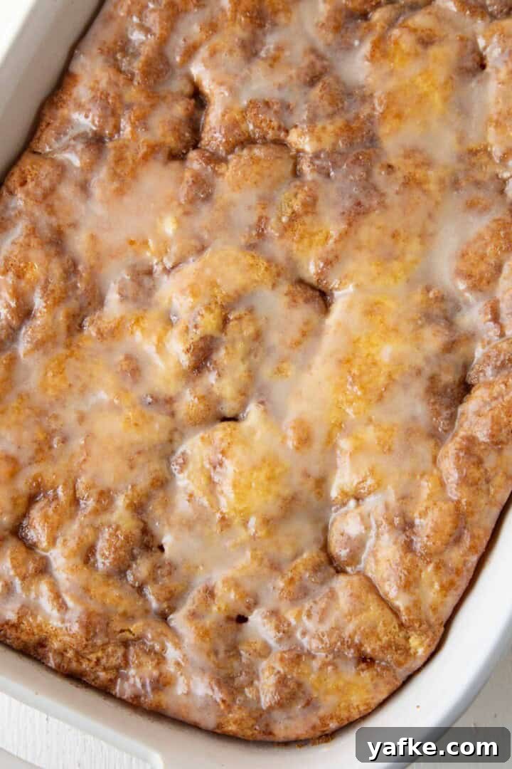 powdered sugar glazed topped honey bun cake.