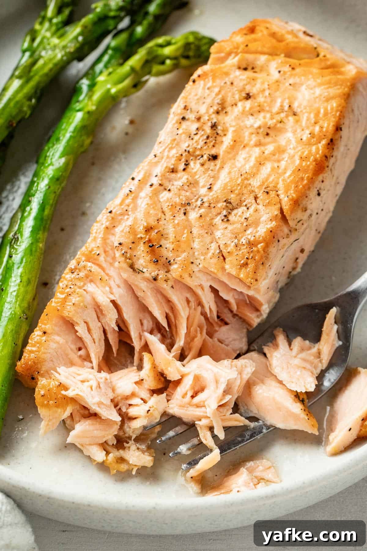 Pan-Seared Salmon with Crispy Skin and Lemon Butter Sauce 2 Golden brown fried salmon flaked with a fork.