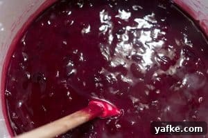 Thickened grape filling being stirred.