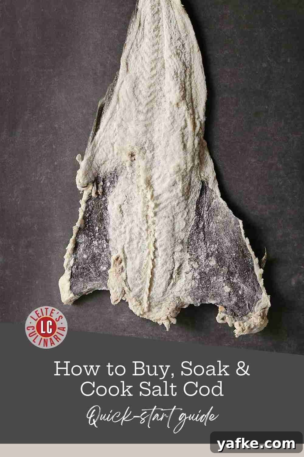 How to Buy, Soak and Cook Salt Cod (Bacalao) 2 A plank of salted cod hanging in front of a gray wall.
