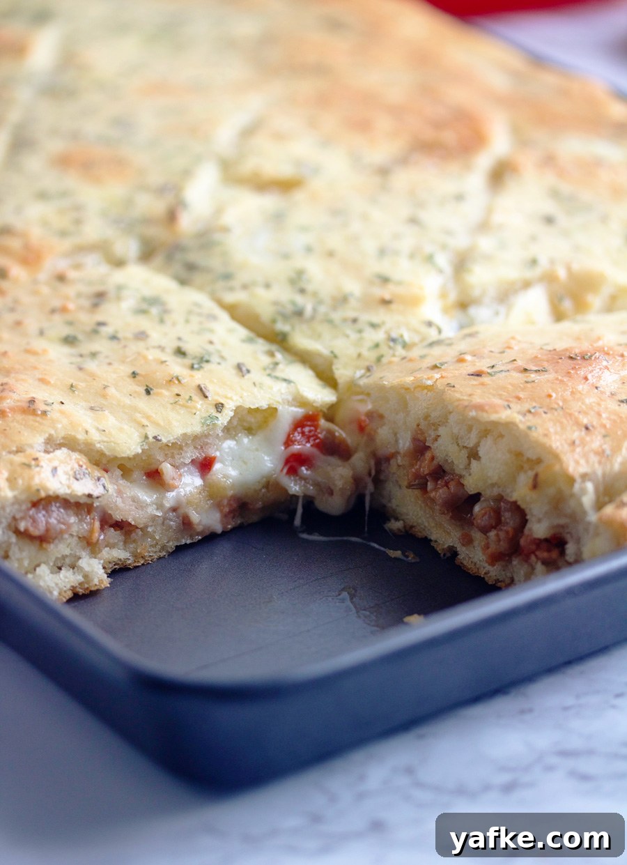 Weekly Meal Plan 158: Family Dinners and Lunches 6 Pan of Sausage Sandwich Squares with a piece cut out