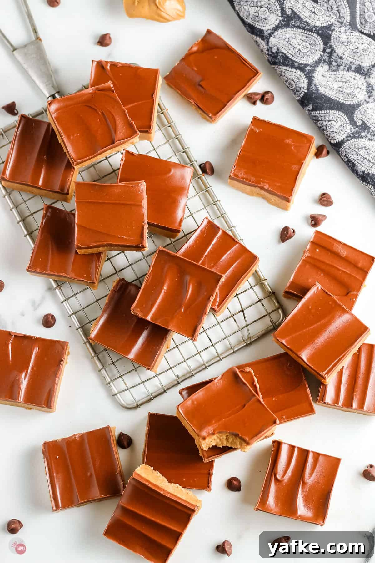 No-Bake Peanut Butter Bars Recipe 8 peanut butter bars spread on a white backdrop